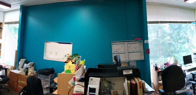 a panorama picture of the centre showing desks, posters, and colourful walls.